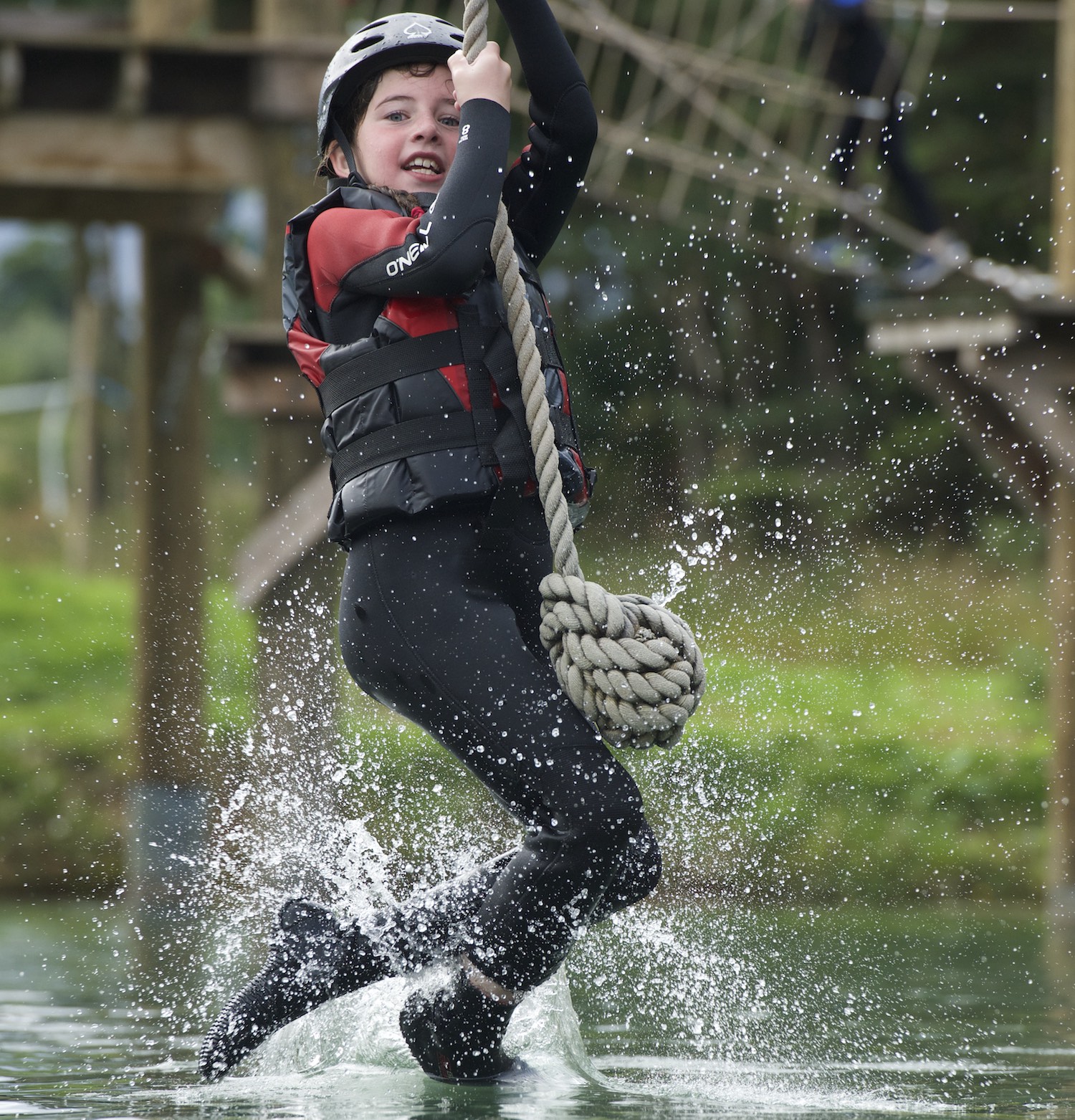 Boy on high rope course at Foxlake Adventures, East Lothian